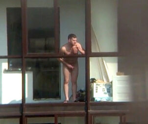 Bare boy on the balcony in spy spycam movie