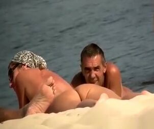 Spycam at naturist beach films naked folks and gal
