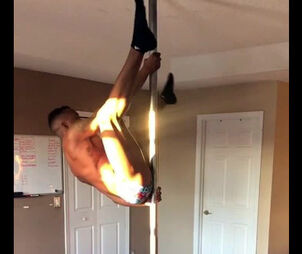 Ebony male stripper rolling on a pole.