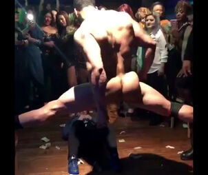 Muscular masculine stripper dancing in the circle of